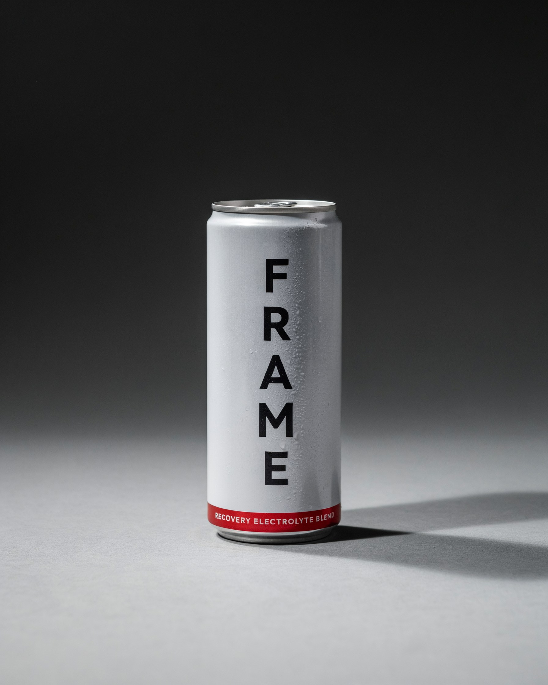 Silver FRAME electrolyte can with a red label, condensation, minimal studio