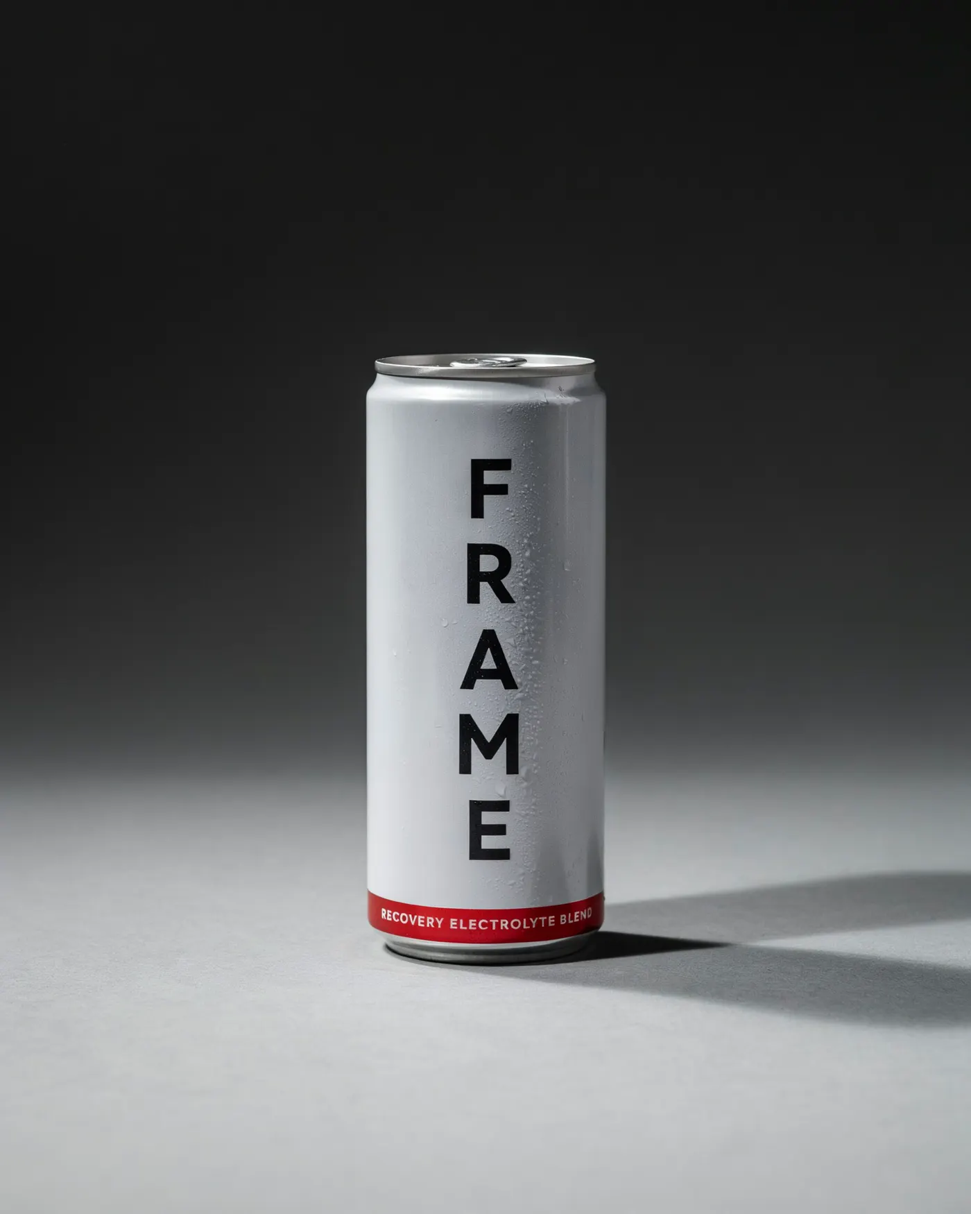 Silver FRAME electrolyte can with a red label, condensation, minimal studio