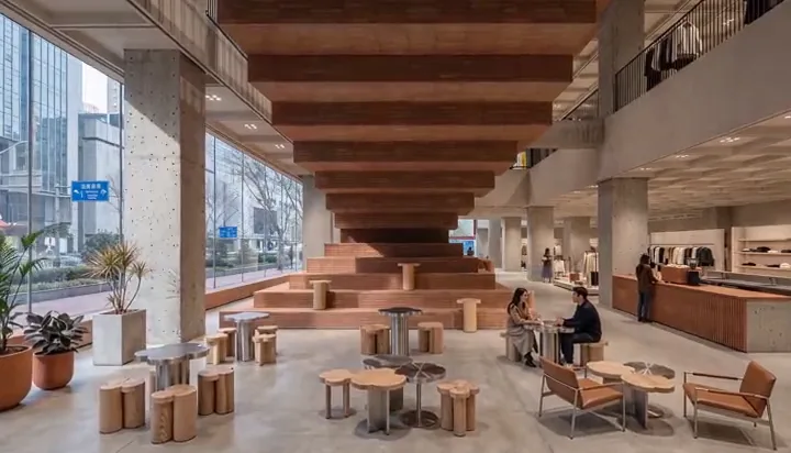 Retail and cafe interior with a dramatic stepped wooden ceiling installation