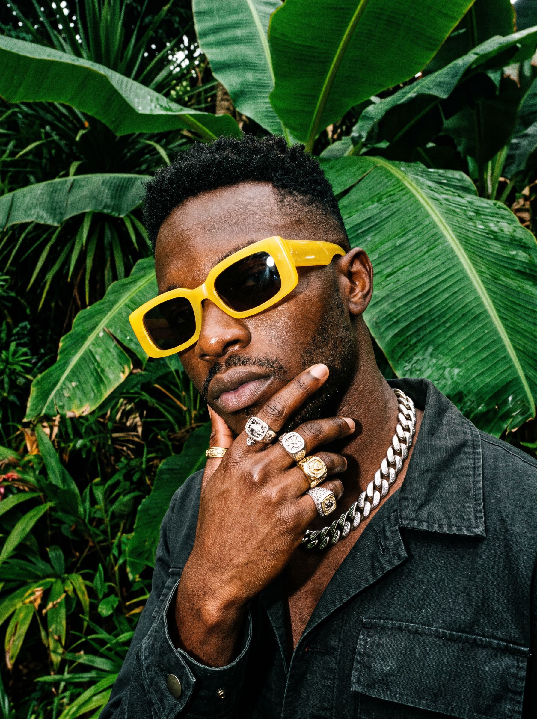 Fashion portrait with yellow sunglasses and tropical leaves